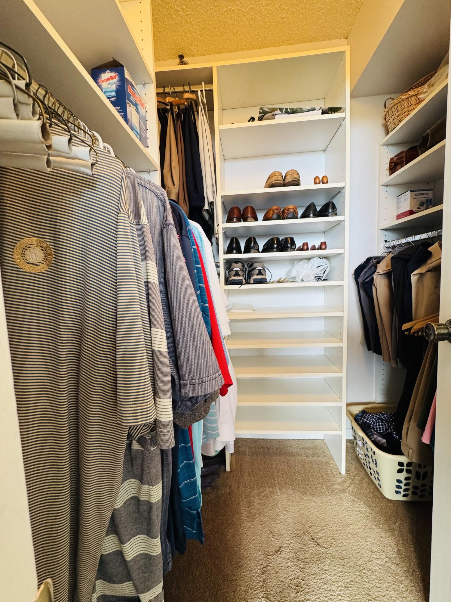 2430 DC Country Club Boulevard, Unit 4072 Deerfield Beach, FL 33442 - Photo 17 of 28 a view of walk in closet with clothes and shoes