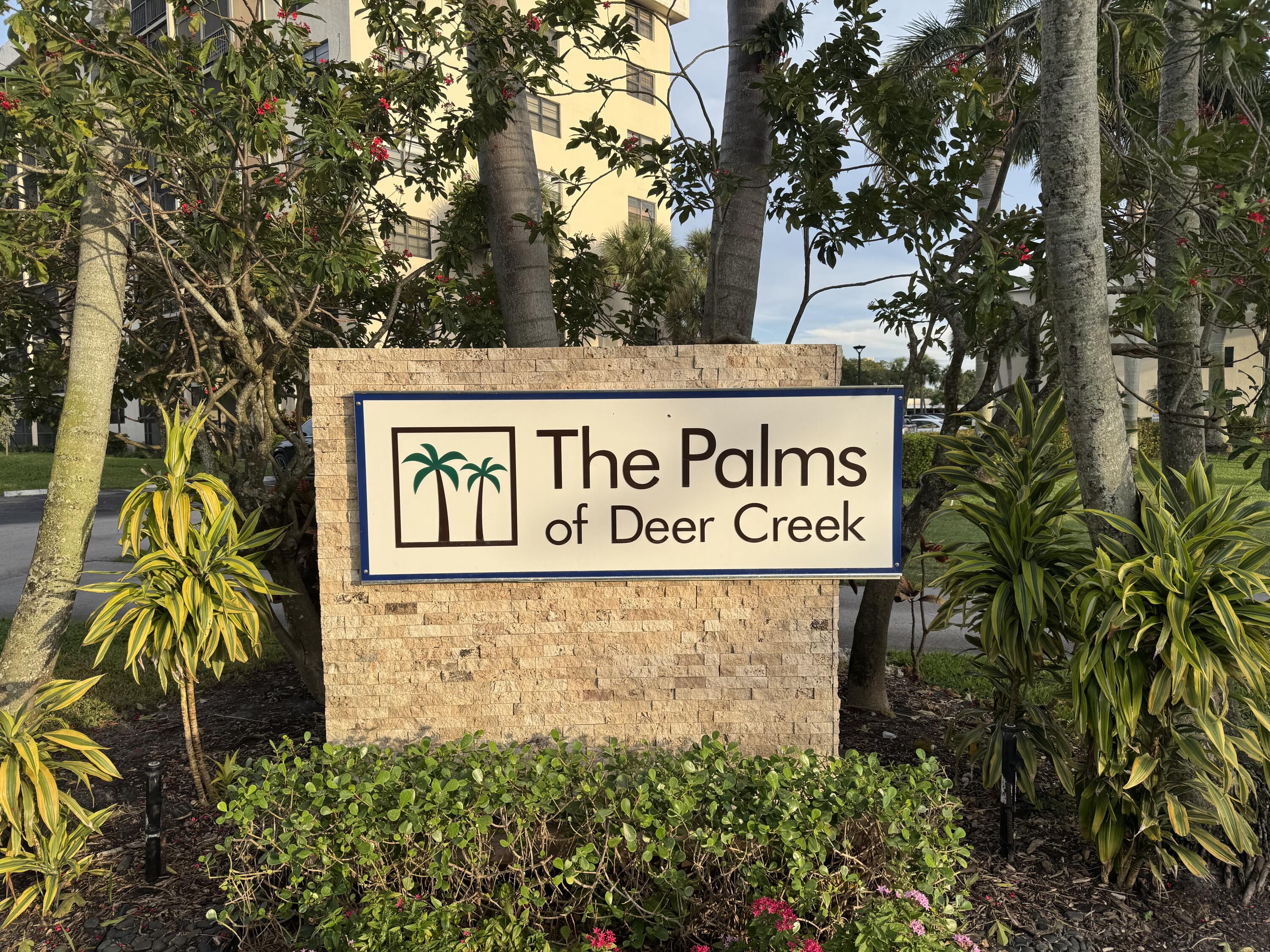 2430 DC Country Club Boulevard, Unit 4072 Deerfield Beach, FL 33442 - Photo 2 of 28 a sign broad in front of flowers
