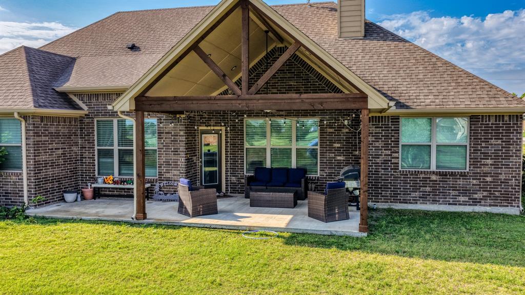 2023 Jo Jones Lane Springtown, TX 76082 - Photo 18 of 25 a front view of house with an outdoor seating