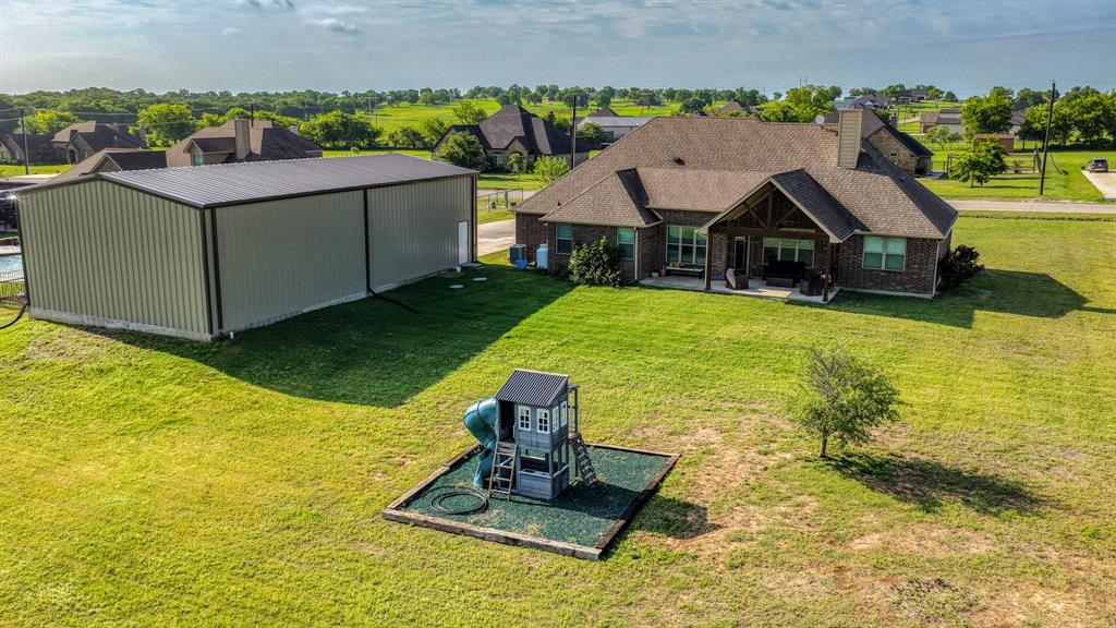 2023 Jo Jones Lane Springtown, TX 76082 - Photo 20 of 25 a view of a house with a yard