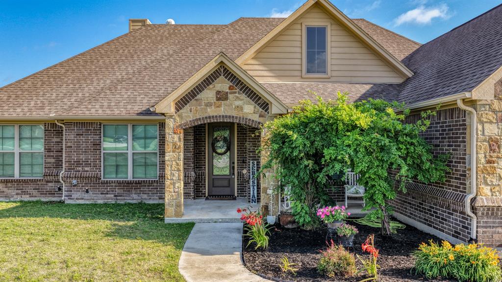2023 Jo Jones Lane Springtown, TX 76082 - Photo 3 of 25 front view of a house with a yard