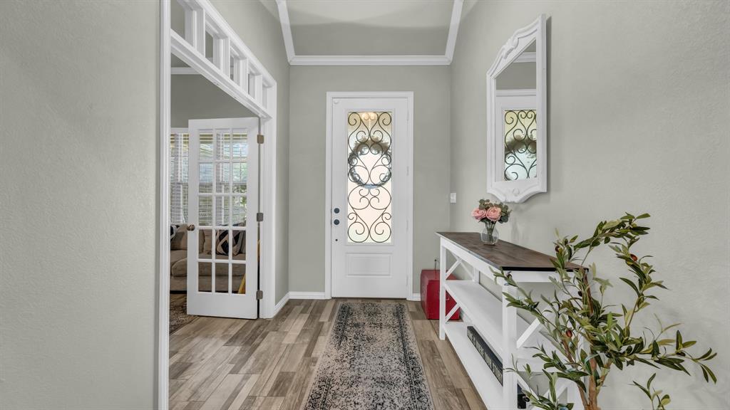 2023 Jo Jones Lane Springtown, TX 76082 - Photo 4 of 25 a hallway with painting on the wall and a window