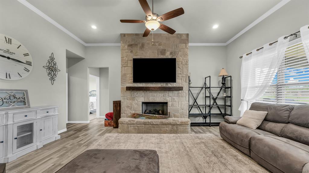2023 Jo Jones Lane Springtown, TX 76082 - Photo 6 of 25 a living room with furniture a fireplace and a flat screen tv