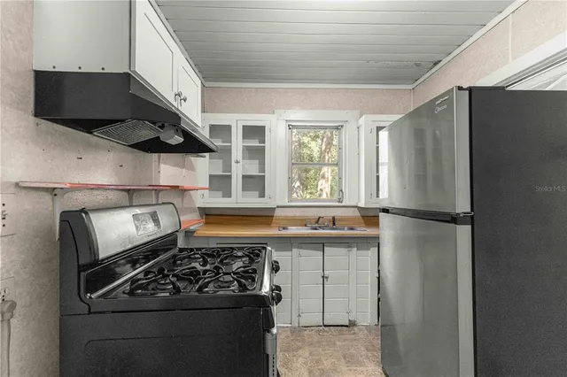 a kitchen with stainless steel appliances granite countertop a stove and a refrigerator