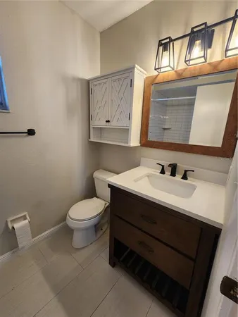 a bathroom with a sink a toilet and mirror