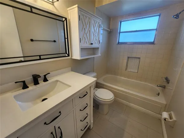 a bathroom with a sink mirror vanity and toilet