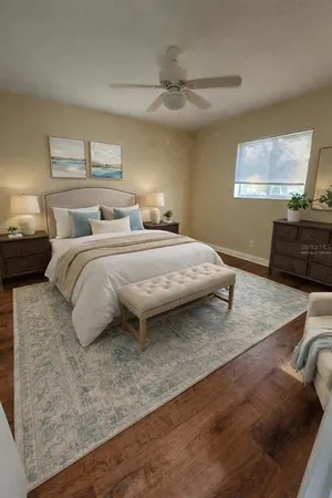 a bedroom with a bed and a flat tv screen on dresser
