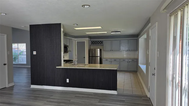 a view of empty room with wooden floor and cabinet