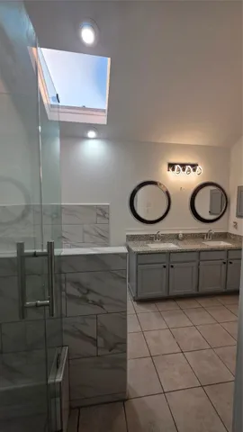 a bathroom with a double vanity sink and a mirror