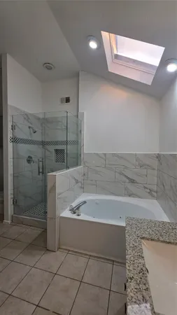 a bathroom with a bathtub and a shower