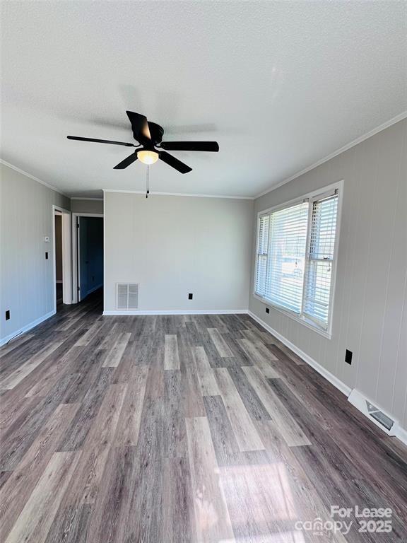 5904 Highway 70 Old Fort, NC 28762 - Photo 3 of 11 a view of empty room with wooden floor and fan
