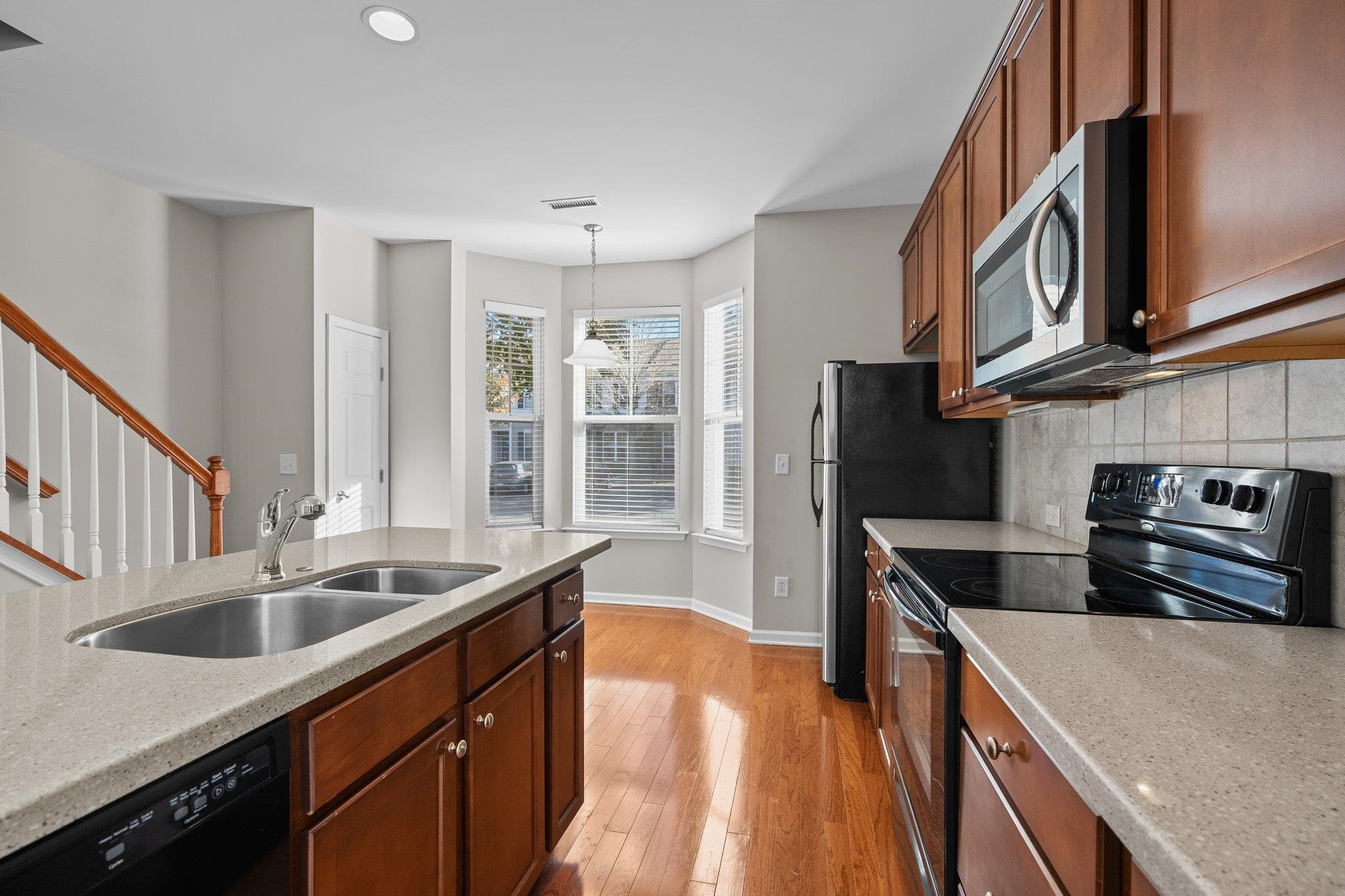 6705 Morgantown Street Raleigh, NC 27616 - Photo 11 of 40 a kitchen with stainless steel appliances granite countertop a sink stove and refrigerator