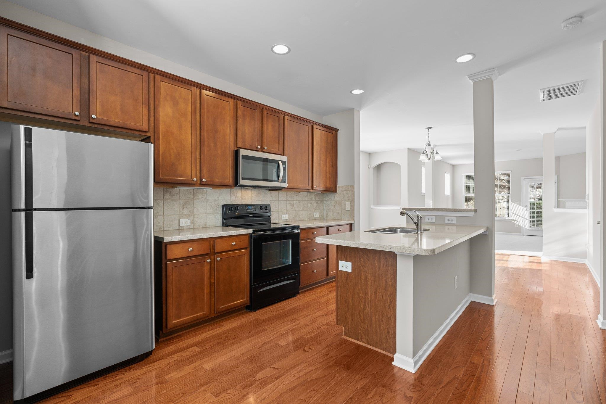 6705 Morgantown Street Raleigh, NC 27616 - Photo 13 of 40 a kitchen with stainless steel appliances granite countertop a refrigerator stove microwave and sink