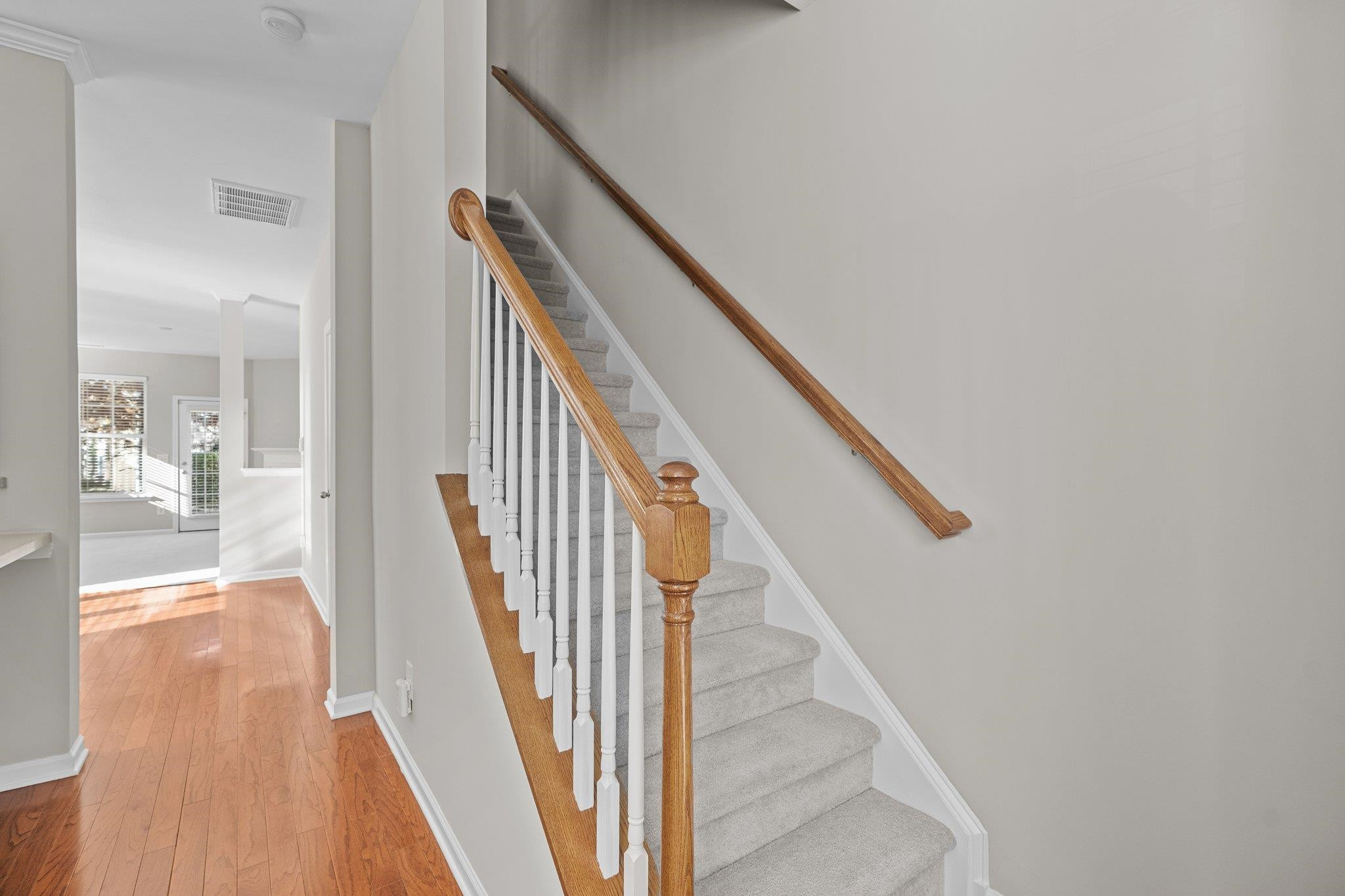 6705 Morgantown Street Raleigh, NC 27616 - Photo 14 of 40 a view of a hallway with wooden floor and staircase
