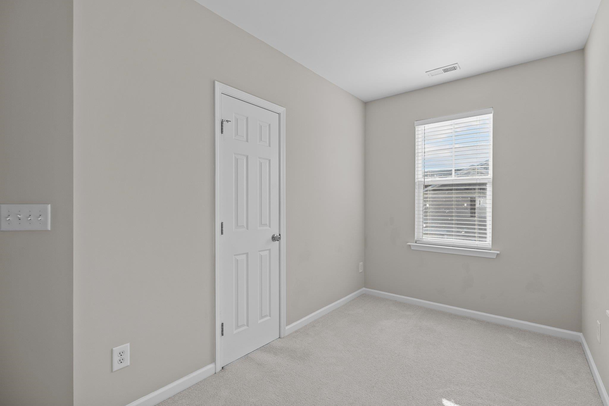 6705 Morgantown Street Raleigh, NC 27616 - Photo 25 of 40 a view of an empty room with a window