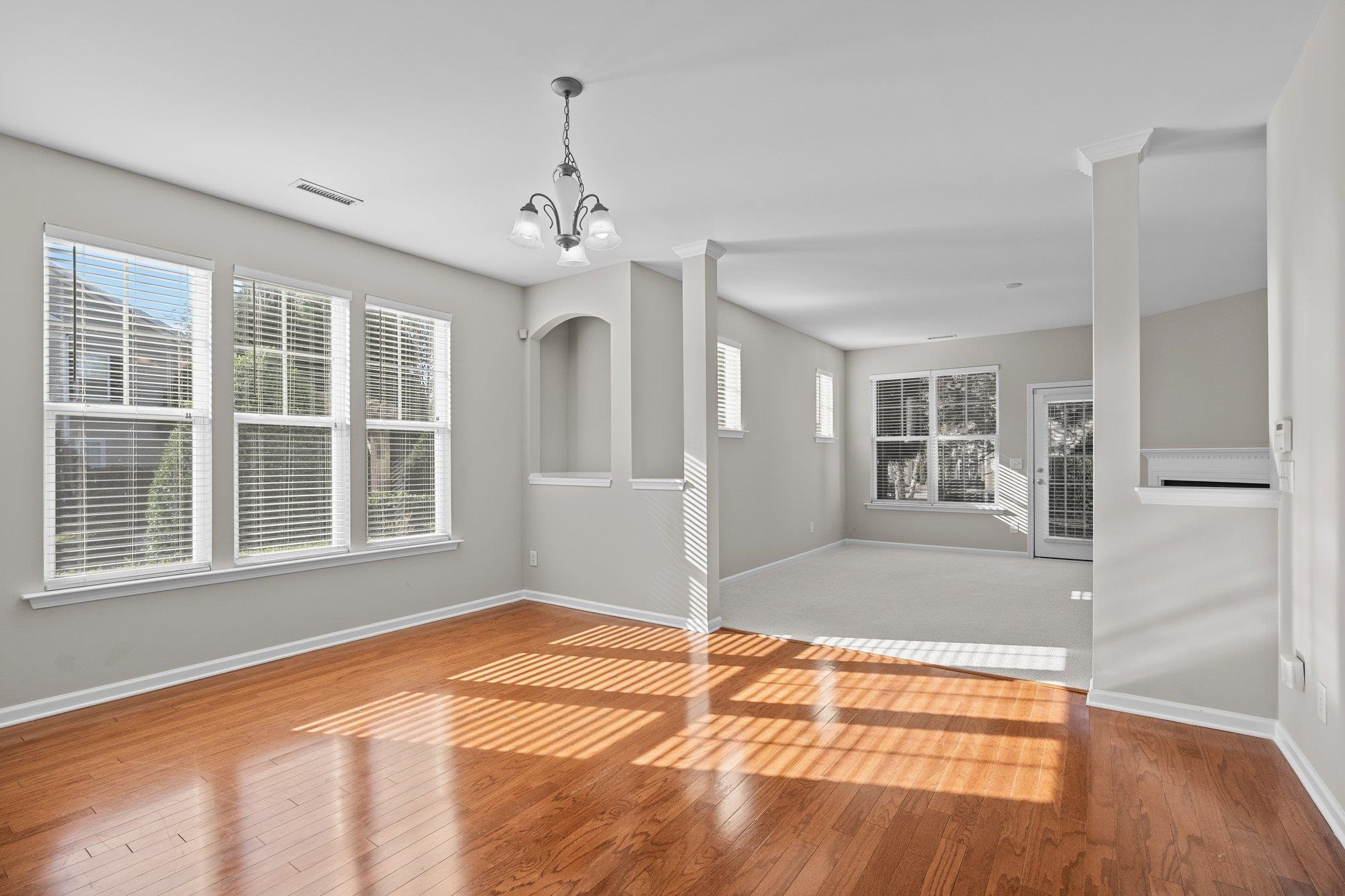 6705 Morgantown Street Raleigh, NC 27616 - Photo 6 of 40 a view of an empty room with wooden floor and a window