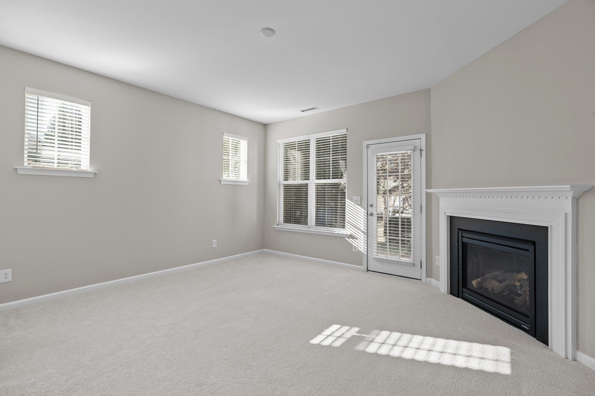 6705 Morgantown Street Raleigh, NC 27616 - Photo 10 of 40 a view of a livingroom with an empty space and a fireplace