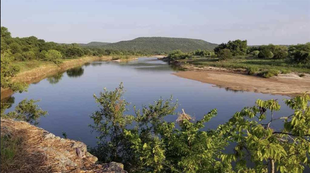 144 River Cyn Road Palo Pinto, TX 76484 - Photo 4 of 9 a view of a lake with mountains in front of it