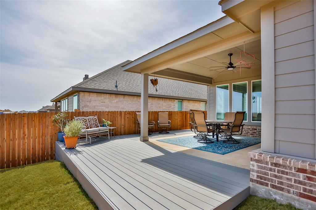 622 Juneau Street Gainesville, TX 76240 - Photo 3 of 39 a view of a patio with table and chairs with wooden floor and fence