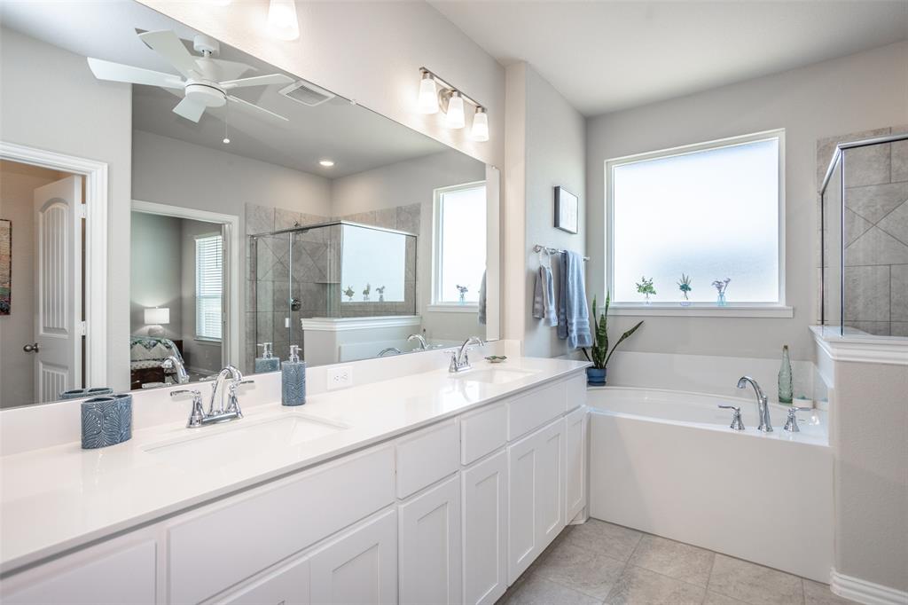 622 Juneau Street Gainesville, TX 76240 - Photo 31 of 39 a bathroom with a sink double vanity and a mirror