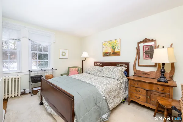 a bed room with a bed and a dresser