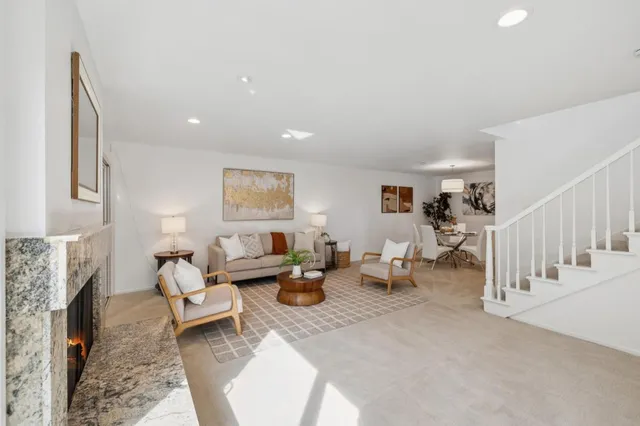 a living room with furniture and a fireplace
