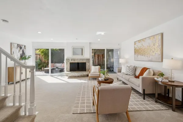 a living room with furniture a fireplace and a flat screen tv