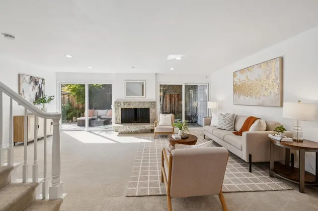 a living room with furniture a fireplace and a flat screen tv