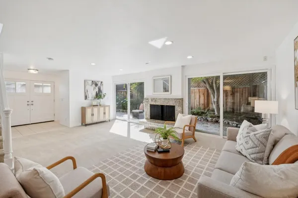 a living room with furniture a fireplace and a table