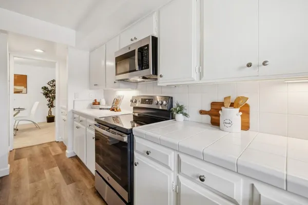 a kitchen with a sink stove and microwave