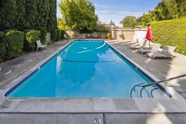 swimming pool view with a seating space