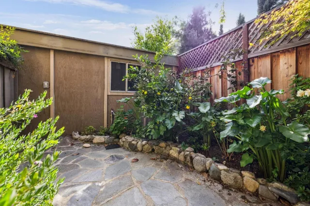a view of a house with a small yard and plants