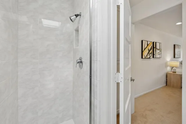a bathroom with a granite countertop sink a toilet and a mirror
