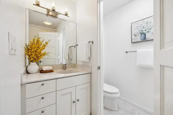 a bathroom with a sink a vanity and a mirror