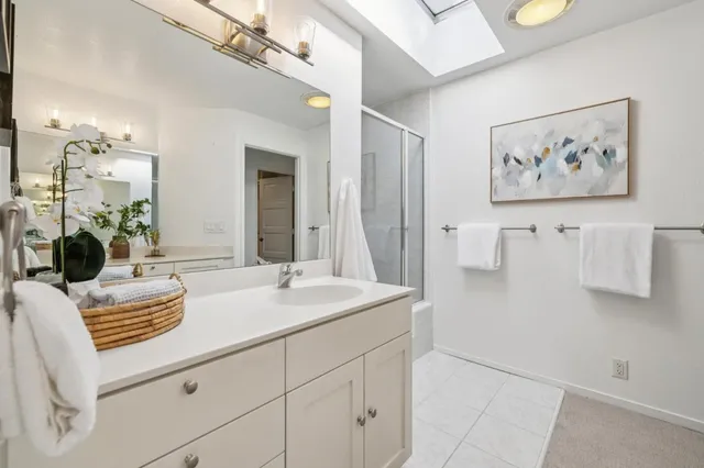 a bathroom with cabinets and mirror
