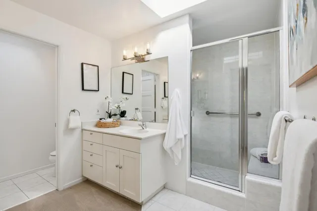 a view of a bedroom with a bed and hallway