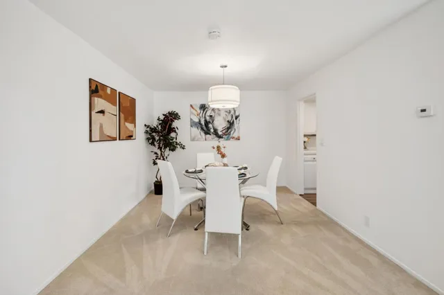 a dining room with furniture and a chandelier
