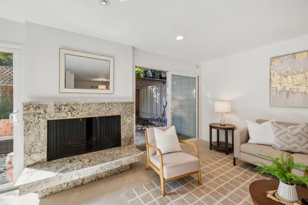 a living room with furniture and a fireplace