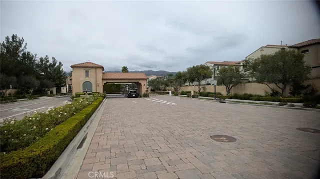 a view of house with a yard and potted plants