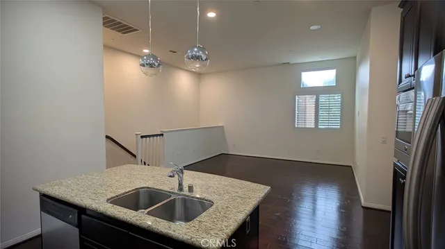 a kitchen with sink cabinets and refrigerator