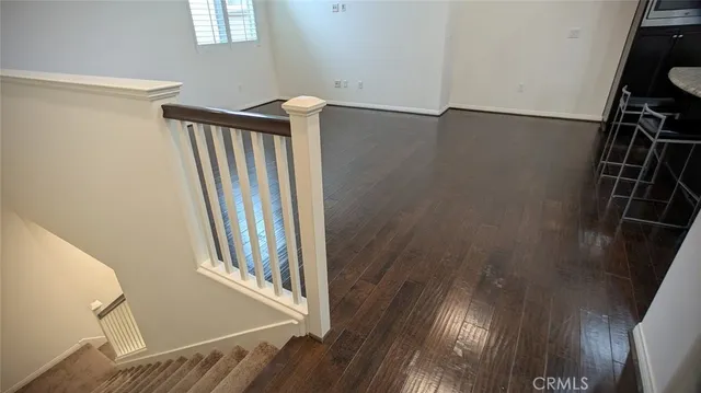 a view of a room with wooden floor and staircase