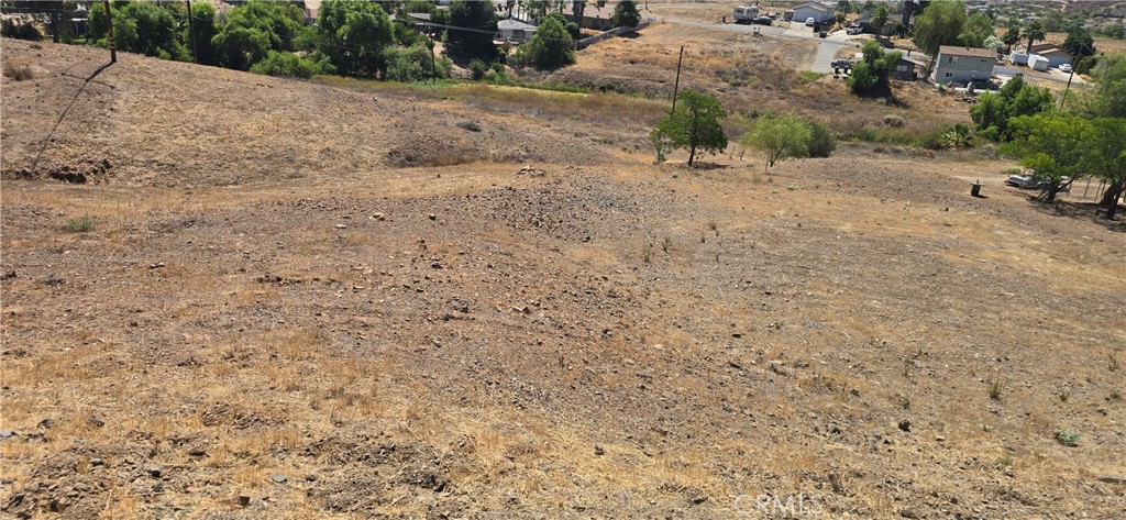 0 Nevada Drive Menifee, CA 92587 - Photo 2 of 4 a view of a dry yard with wooden fence