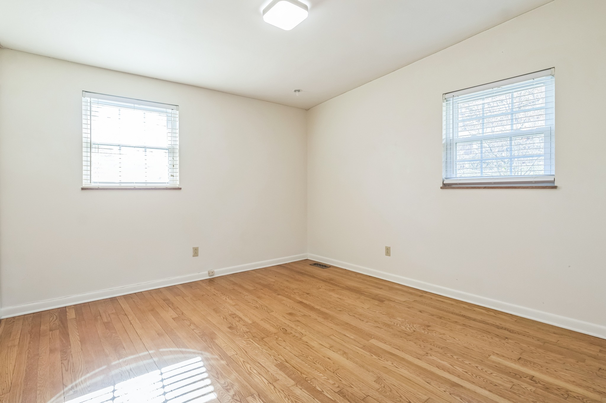 101 Locust Lane Oak Ridge, TN 37830 - Photo 7 of 33 an empty room with wooden floor and windows