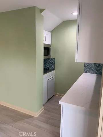 a kitchen with a sink and a stove top oven