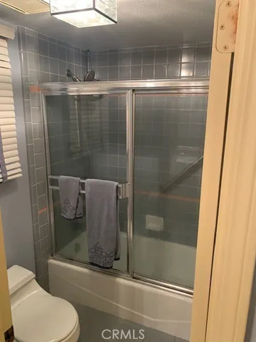 a bathroom with a shower and toilet