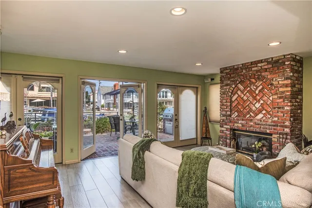 a living room with fireplace furniture and a floor to ceiling window