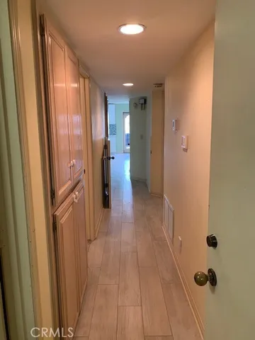 a view of a hallway with wooden floor