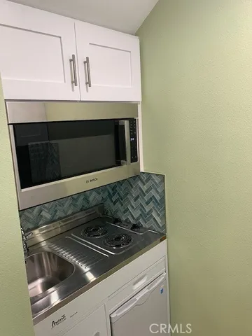 a stove top oven sitting inside of a kitchen