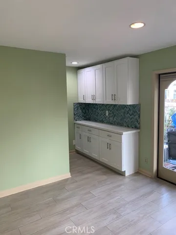 a kitchen with granite countertop a stove a sink and a microwave