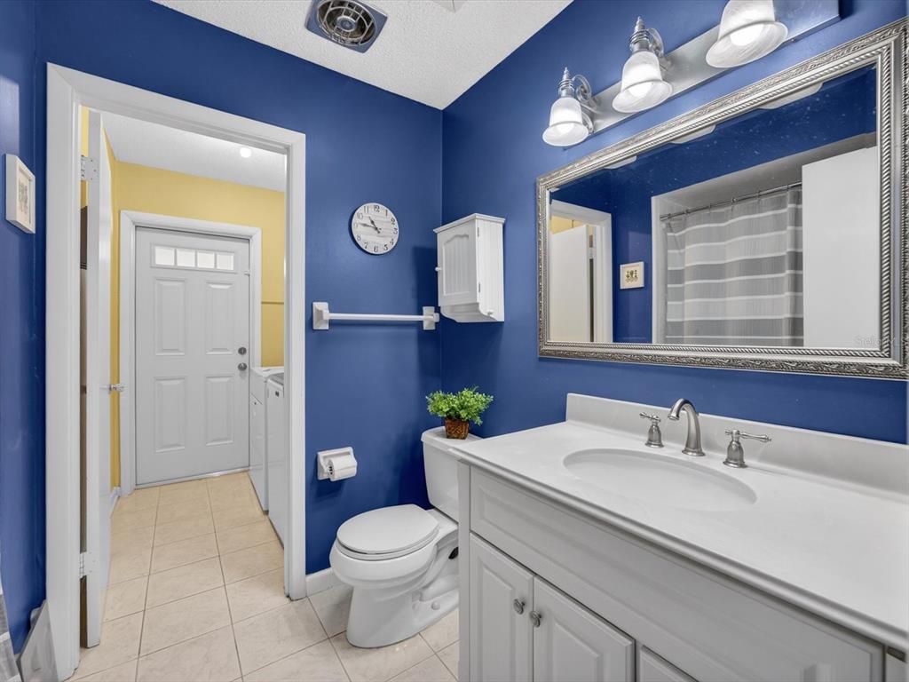 2803 Banchory Road Winter Park, FL 32792 - Photo 18 of 31 a bathroom with a granite countertop toilet sink and mirror
